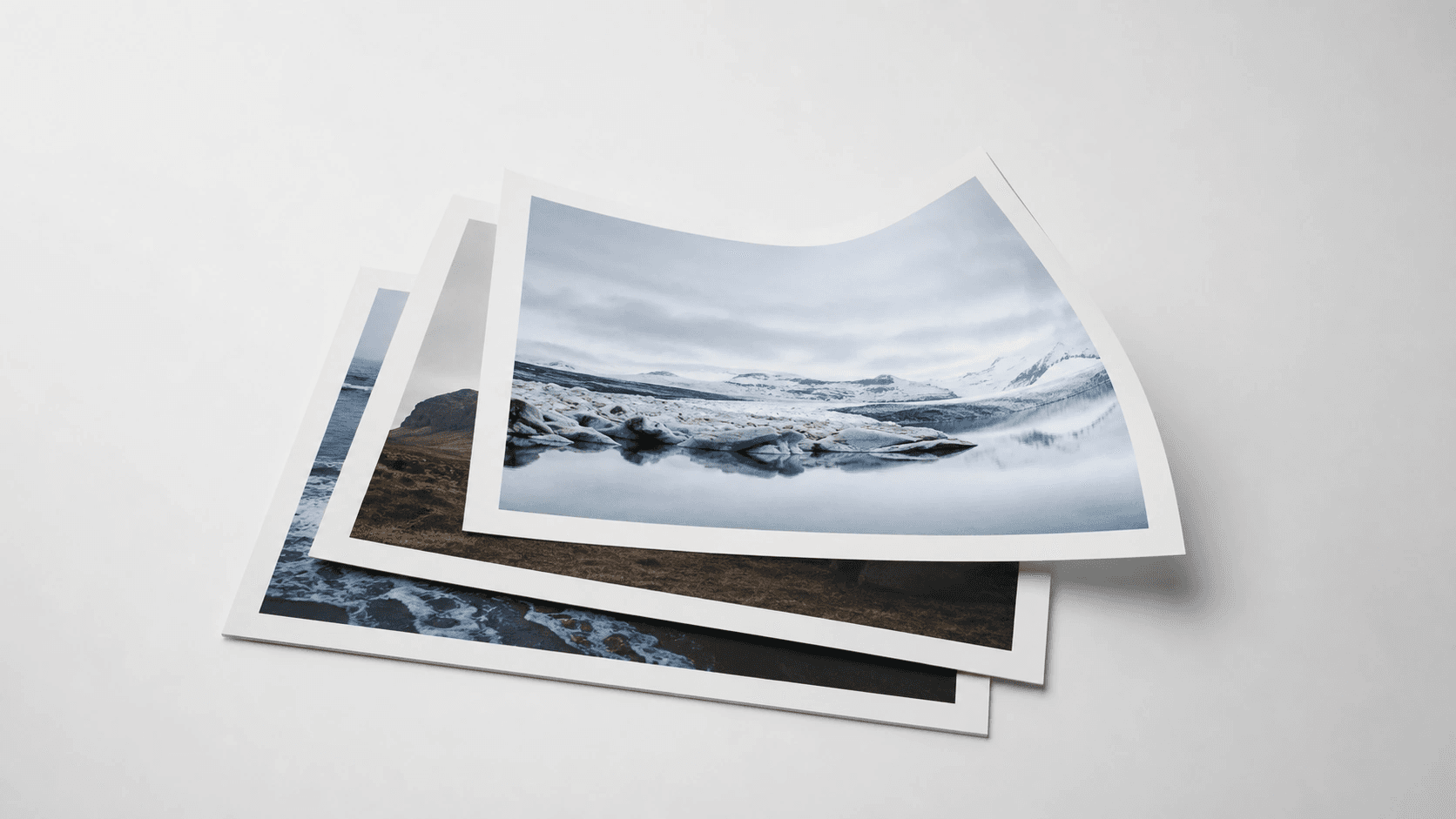 Printed photos stacked into a clean document bundle on a neutral studio surface